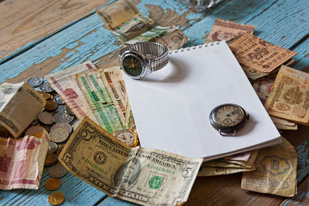 Energy efficiency concept, energy savings and progress. Bulb incandescent lamp and dollars against wooden table, place for text. Concept of energy conservation, green technologyの写真素材