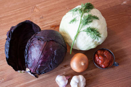 Set of vegetables cabbage potatoes carrots onion garlic parsley dill beet ginger on a wooden table backgroundの写真素材