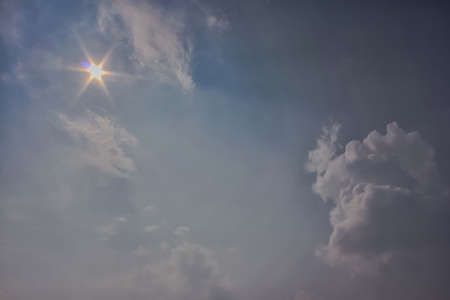 The sun shines bright in the daytime in summer. Blue sky and clouds.