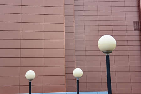 Fixtures of street lighting against the background of the light-brown wallの写真素材