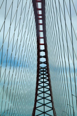 Abstract view of bridge support against a blue sky.