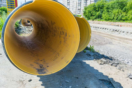 Pipes of PVC large diameter prepared for laying on construction siteの写真素材