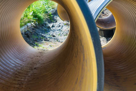 Pipes of PVC large diameter prepared for laying on construction siteの写真素材