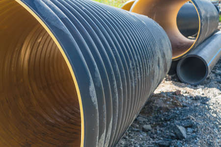 Pipes of PVC large diameter prepared for laying on construction site