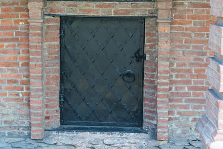 Fragment of red vintage old brick wall with windows. Textural background.の写真素材