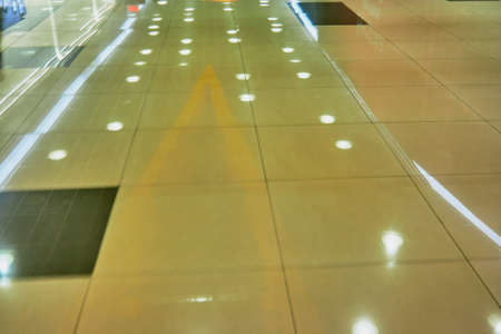 Reflection in the polished floor tile of a large shopping center