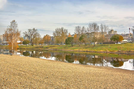 Autumn landscape in the city park by the river