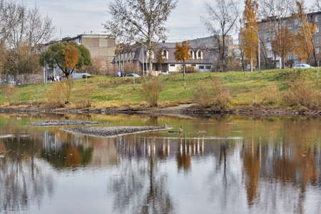 Autumn landscape in the city park by the river