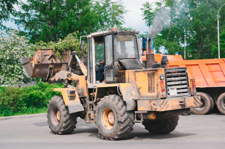Heavy equipment eliminates the consequences of a hurricane on the streets of the city