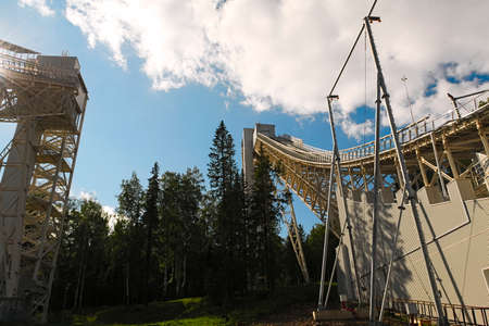 Metal structures of a large ski jumping-off against the sky and cloudsの写真素材