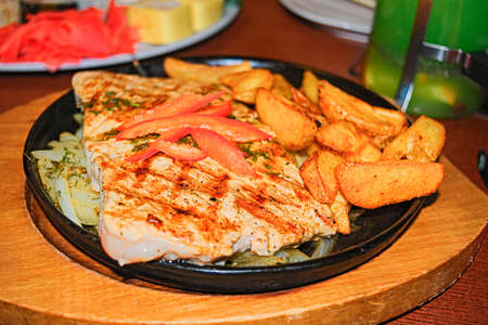 Grilled steaks with fries and vegetable saladの写真素材