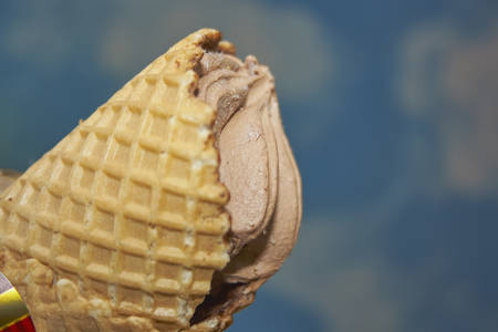 Chocolate ice cream cone on blurred background close-upの写真素材