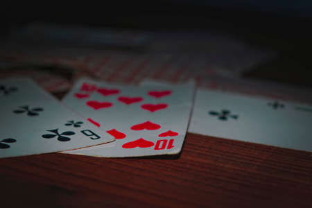 Old playing cards on wooden background close-upの写真素材
