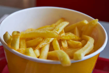 French fries in a yellow box close-upの写真素材