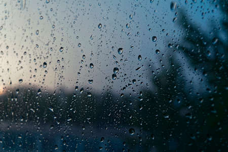 Lake through the window glass covered by raindropsの写真素材