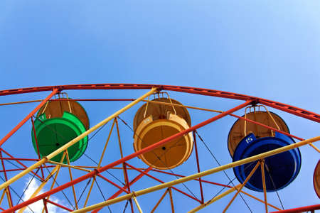 Ferris wheel against the blue summer sky in the city parkの写真素材