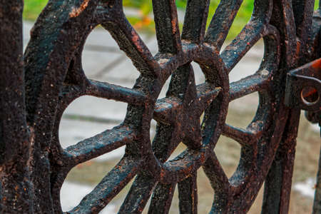 Fragment of an old cast-iron fence close-upの写真素材