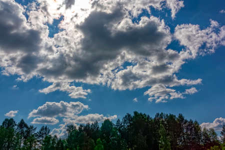 Blue summer sky with white cumulus clouds