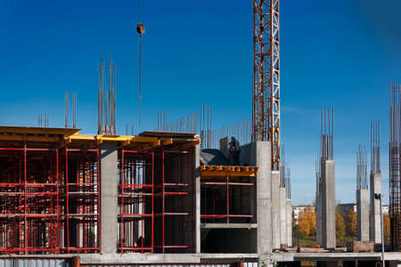 Construction of a mall cranes on a background of blue summer sky