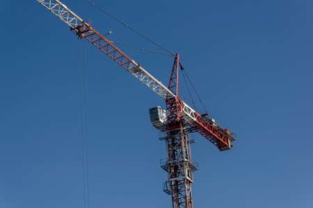 Construction of a mall cranes on a background of blue summer skyの写真素材
