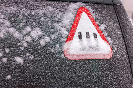 Frozen car windshield covered with ice and snow.の写真素材