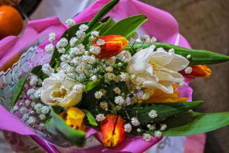 bouquet of tulips. a large bunch of orange and white tulips. festive spring bouquet. spring flowers.の写真素材