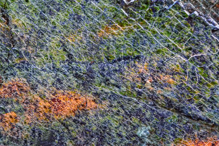 background, texture - rough surface of cliff from serpentinite, natural stone with a green tint