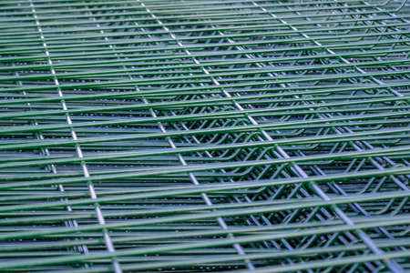 package of galvanized steel panels for the fence with a powder coated green color close-up
