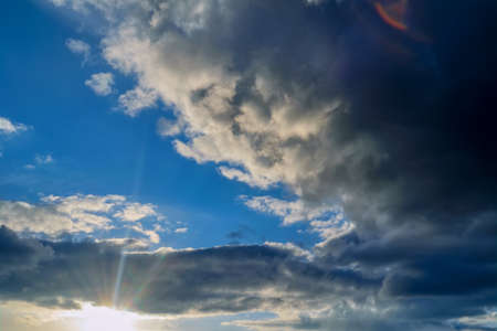 Dramatic evening sky with beautiful clouds illuminated by the setting sun.の写真素材