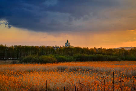 Dramatic sunset on the banks of the city pond. Spring landscape.の写真素材