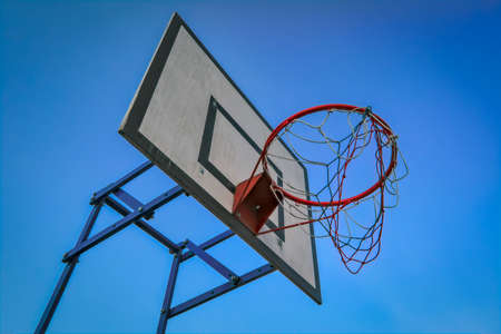 Basketball basket on blue sky background. Basketball basket and board on the blue sky background....