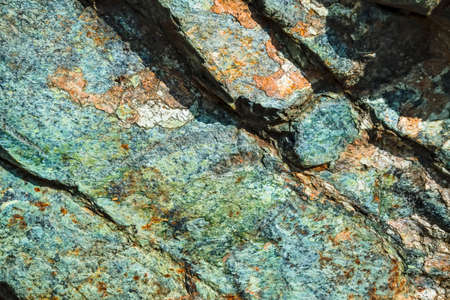 Natural Surface texture of serpentinite. Background with green mineral rock close up, gemstone texture.の写真素材