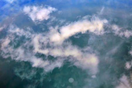 Blue sky. Blue sky and white clouds reflected in water.