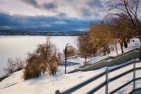 Embankment of the city pond winter city landscape.の写真素材