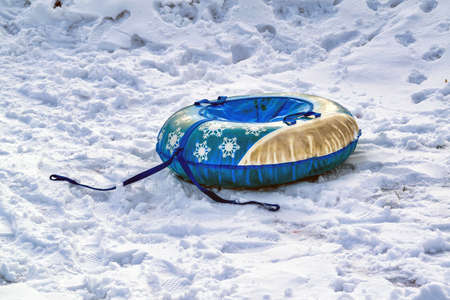 Children's inflatable rubber round sled tubing for winter ride with slides.の写真素材