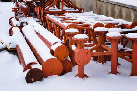 Metal structures on the street covered by snow.