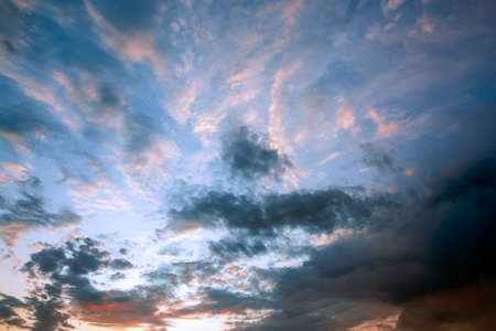 Multi colored clouds at sunset. The clouds lit by the setting sun.