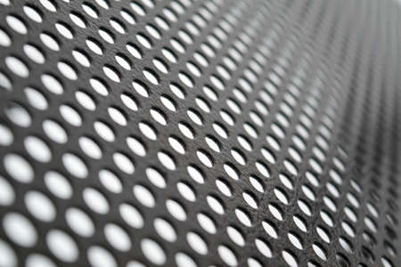 Perforated metallic grid, industrial background. Steel plate with holes.の写真素材