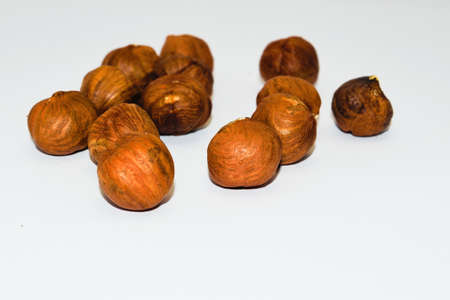 Unshelled hazel nuts isolated on white, food background.