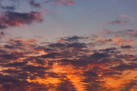 Spring evening sky in the picturesque clouds, lit by the rays of the setting sun.