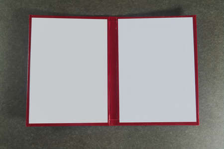 Opened book cover on a dark background close-up.の写真素材