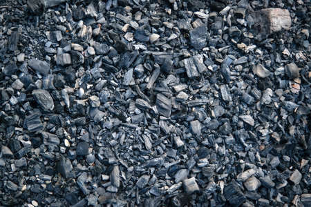 Black charcoal texture background. Close-up shot. Top view. Close-up charcoal texture.