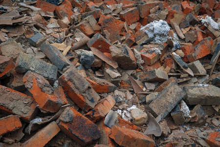 Close-up of a pile of old broken red bricks.