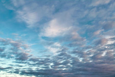 White fluffy clouds in the blue sky. Blue summer sky with white cumulus clouds.