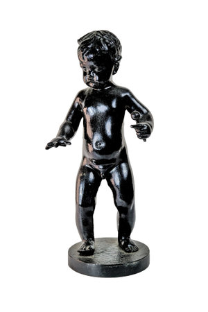 Black color cast-iron figurine of a boy isolate on a white background.の写真素材