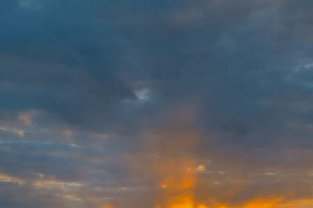Summer evening sky in the picturesque clouds, lit by the rays of the setting sun.