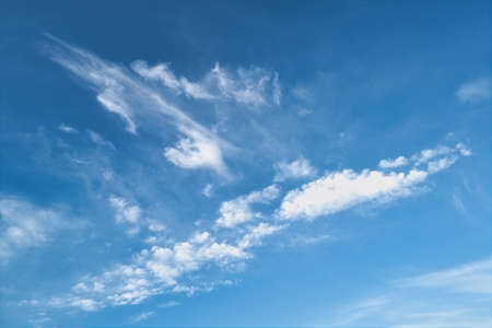 White fluffy clouds in the blue sky. Blue summer sky with white cumulus clouds.