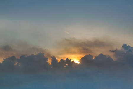 Evening sky in the picturesque clouds, lit by the rays of the setting sun.