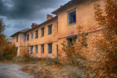 Old abandoned collapsing building. Landscape with the ruins of the old buildings.の写真素材