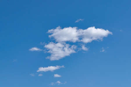White fluffy clouds in the blue sky. Blue summer sky with white cumulus clouds.の写真素材